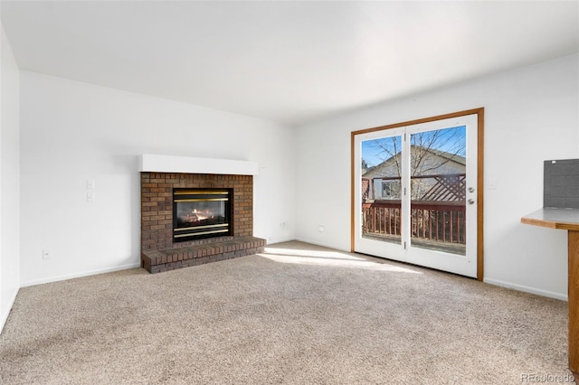 unfurnished living room featuring a fireplace and light colored carpet