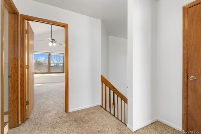 corridor featuring light carpet and lofted ceiling