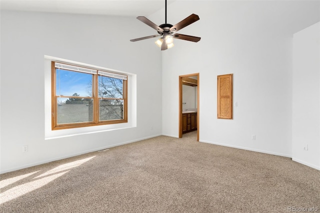 unfurnished room with ceiling fan, light carpet, and high vaulted ceiling