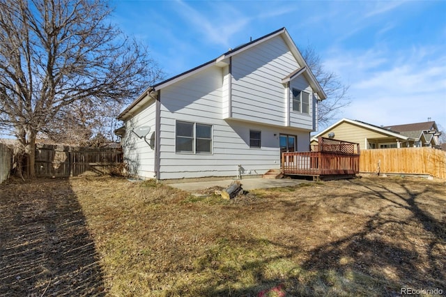 back of property featuring a yard and a deck