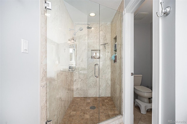 bathroom with tile patterned floors, toilet, and walk in shower