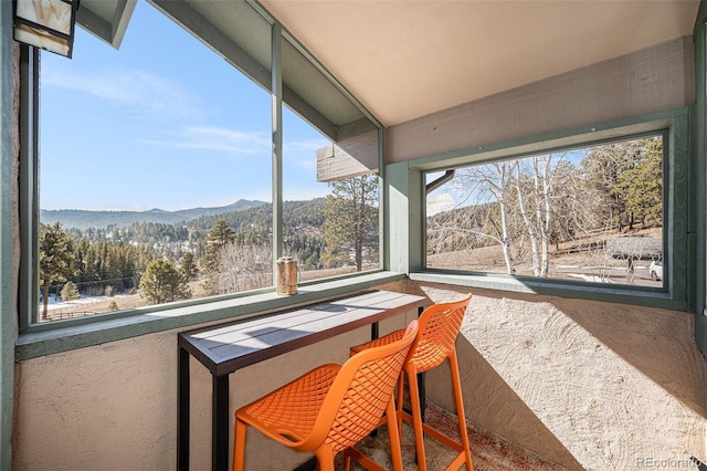 sunroom with a mountain view