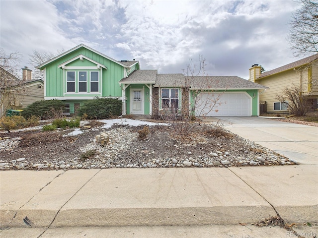 view of front facade featuring an attached garage, concrete driveway, and a shingled roof