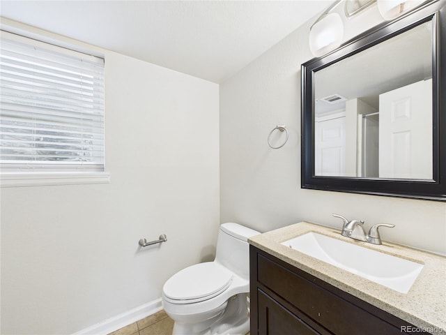 bathroom featuring vanity, baseboards, visible vents, tile patterned floors, and toilet