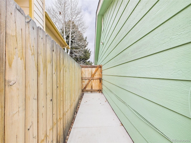 view of side of property with a gate and fence