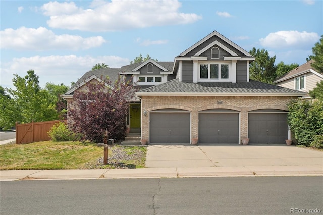 5564 S Jasper Way, Centennial, CO 80015 - view of front of home featuring driveway, roof with shingles, brick siding, and a garage