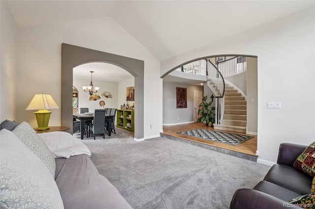 5564 S Jasper Way, Centennial, CO 80015 - carpeted living area featuring arched walkways, stairs, high vaulted ceiling, and a chandelier