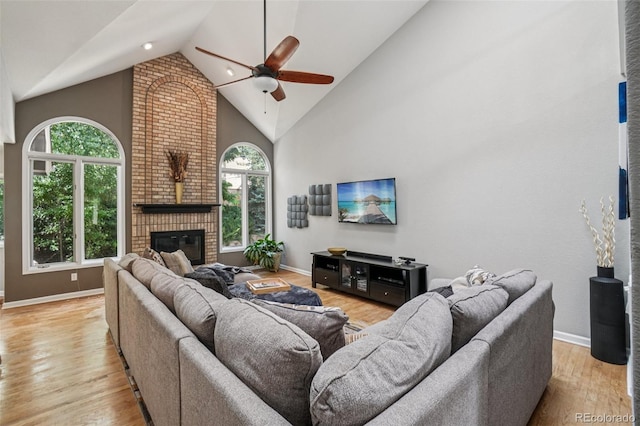 5564 S Jasper Way, Centennial, CO 80015 - living room featuring a ceiling fan, high vaulted ceiling, a brick fireplace, and wood finished floors