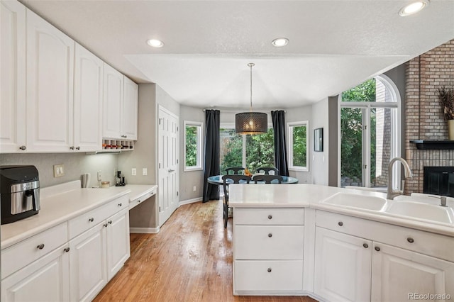 5564 S Jasper Way, Centennial, CO 80015 - kitchen featuring light wood-style floors, white cabinetry, light countertops, pendant lighting, and recessed lighting