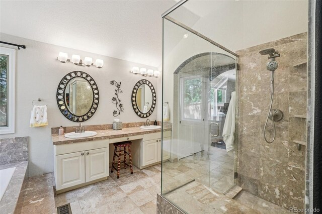5564 S Jasper Way, Centennial, CO 80015 - bathroom featuring a shower stall, double vanity, plenty of natural light, and a tub with marble appearance