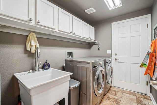 5564 S Jasper Way, Centennial, CO 80015 - washroom with cabinet space, washing machine and clothes dryer, and light stone finish floors