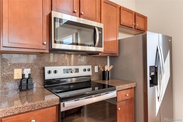 kitchen with appliances with stainless steel finishes and tasteful backsplash