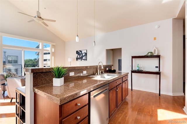 kitchen featuring vaulted ceiling, dishwasher, light wood-type flooring, ceiling fan, and sink