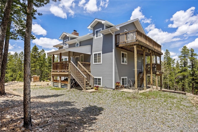 266 Gap Rd, Black Hawk, CO 80422 - back of house featuring stairs, a wooden deck, and a chimney