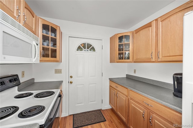 266 Gap Rd, Black Hawk, CO 80422 - kitchen featuring white appliances, light wood-style flooring, glass insert cabinets, and dark countertops