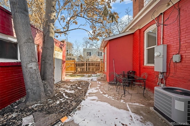 exterior space with central AC unit and a patio