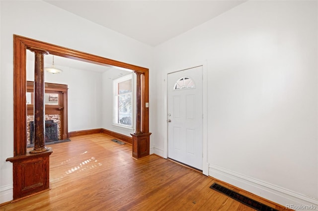 interior space with a fireplace and hardwood / wood-style flooring