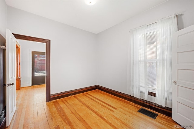 unfurnished room with wood-type flooring