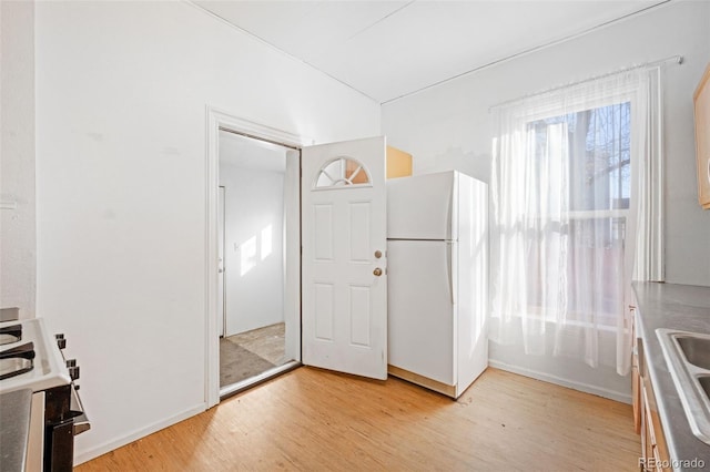 foyer featuring light wood-type flooring and sink