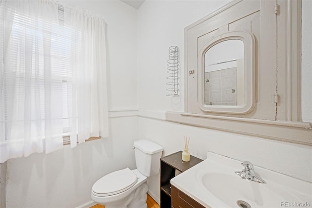 bathroom featuring toilet and vanity