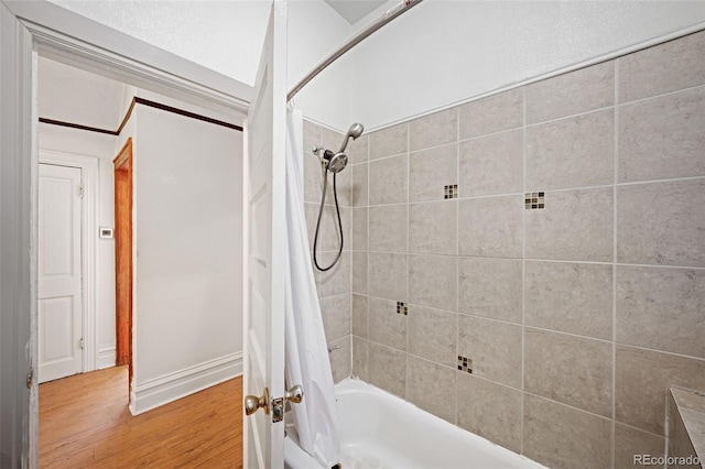 bathroom with shower / bath combo with shower curtain and hardwood / wood-style flooring