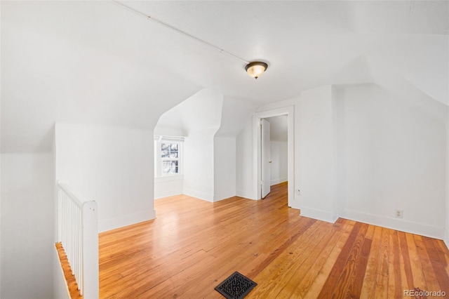 bonus room featuring lofted ceiling and hardwood / wood-style flooring