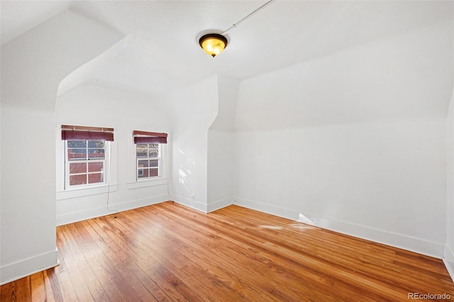 bonus room featuring lofted ceiling and wood-type flooring