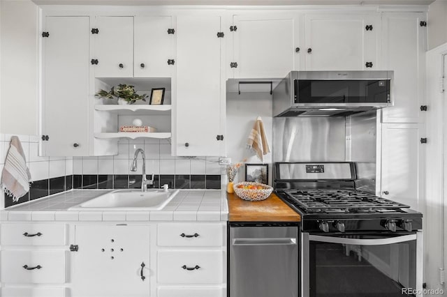 2616 Utica St, Denver, CO 80212 - kitchen with appliances with stainless steel finishes, a sink, tile counters, and decorative backsplash
