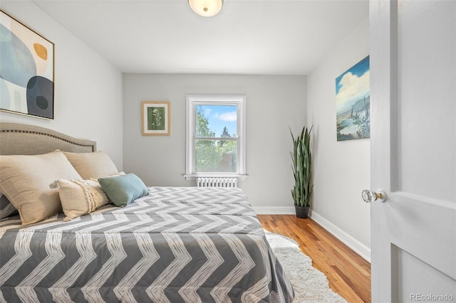 2616 Utica St, Denver, CO 80212 - bedroom with radiator heating unit, wood finished floors, and baseboards