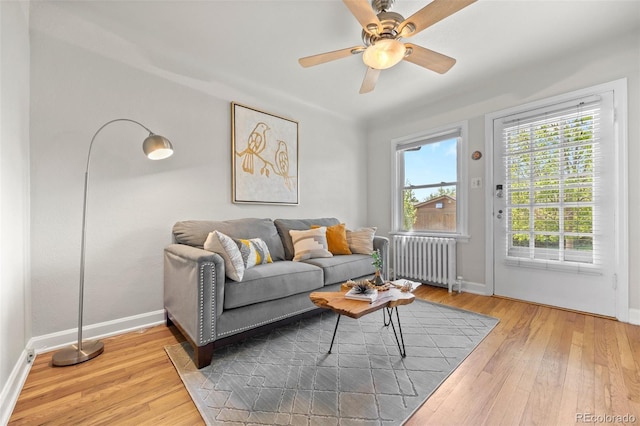 2616 Utica St, Denver, CO 80212 - living area featuring radiator heating unit, baseboards, hardwood / wood-style flooring, and ceiling fan