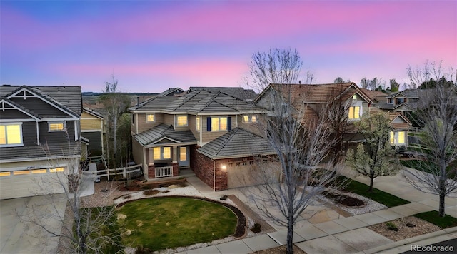 12850 Ventana St, Parker, CO 80134 - traditional home featuring concrete driveway, a garage, brick siding, and a porch