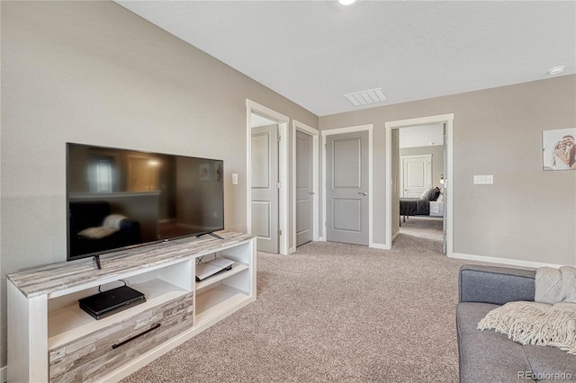 living area featuring light carpet, visible vents, and baseboards