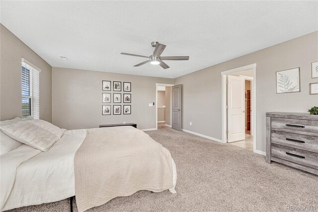 bedroom with visible vents, a ceiling fan, light carpet, a textured ceiling, and baseboards