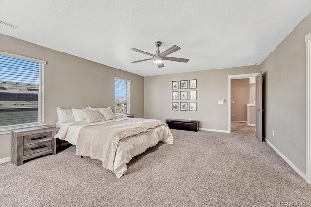 carpeted bedroom with ceiling fan, a textured ceiling, visible vents, and baseboards