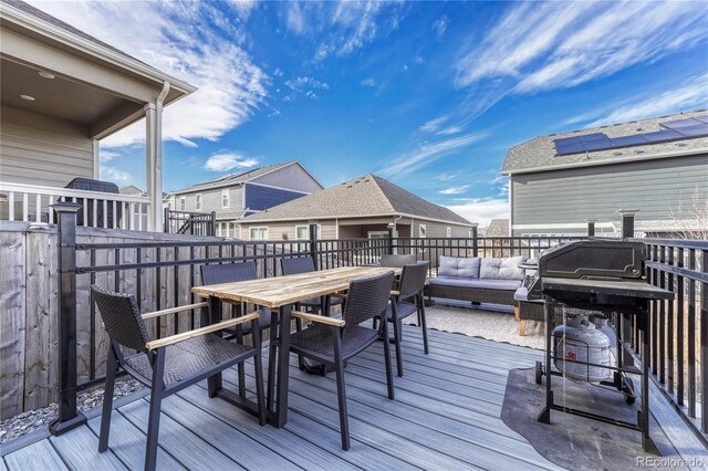 wooden terrace with outdoor dining area and an outdoor living space