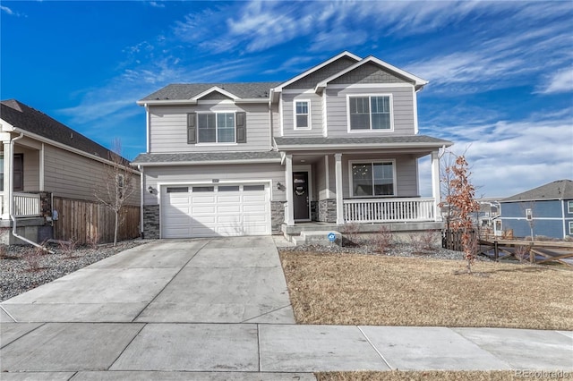 view of front of house featuring covered porch, a garage, fence, driveway, and stone siding