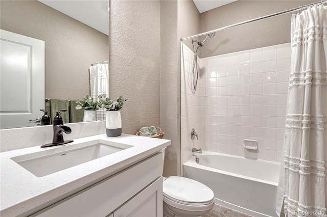 full bath with a textured wall, shower / tub combo with curtain, vanity, and toilet