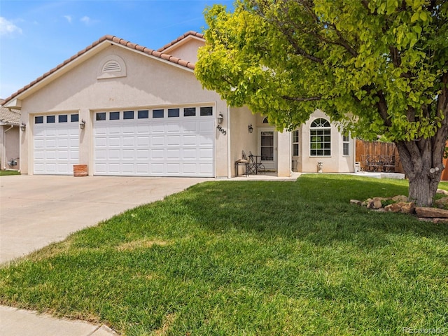 view of front of home with a garage and a front lawn