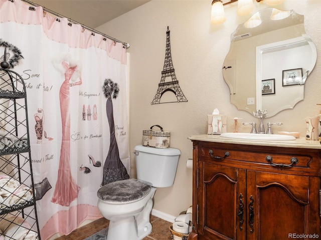 bathroom featuring tile patterned floors, vanity, and toilet