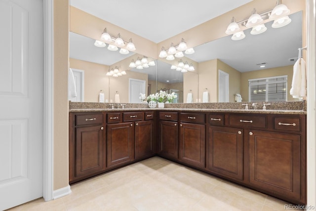 bathroom with double vanity and tile patterned floors