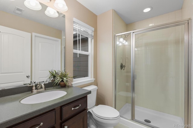 full bath featuring a stall shower, toilet, and vanity