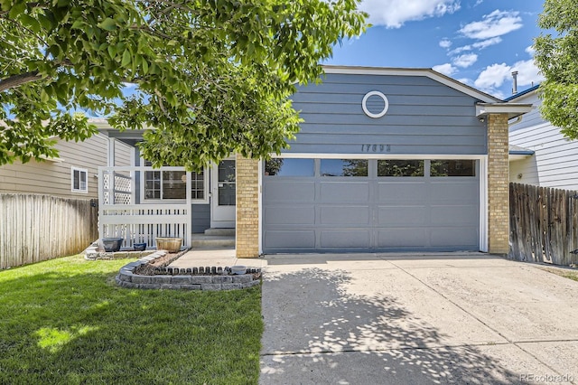 17692 E Brown Cir, Aurora, CO 80013 - view of front facade with concrete driveway, a garage, and brick siding
