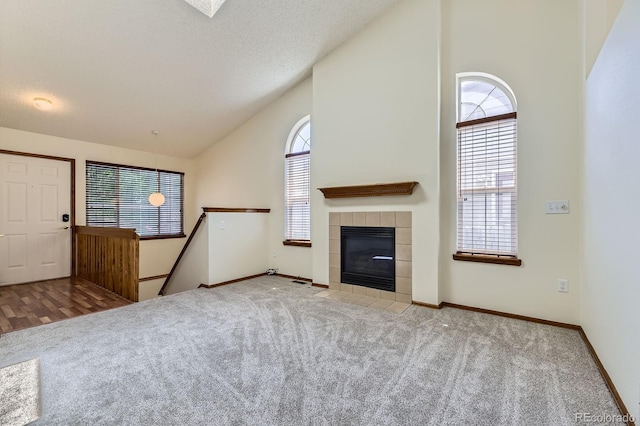 17692 E Brown Cir, Aurora, CO 80013 - unfurnished living room with carpet floors, a fireplace, and high vaulted ceiling