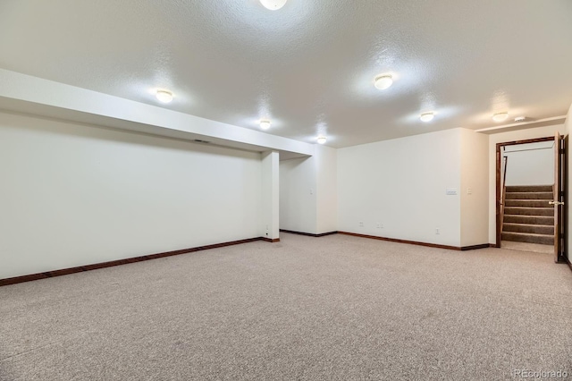 17692 E Brown Cir, Aurora, CO 80013 - finished basement featuring a textured ceiling, stairs, and light carpet