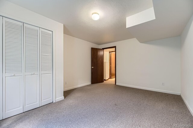 17692 E Brown Cir, Aurora, CO 80013 - unfurnished bedroom featuring carpet floors, a closet, and a textured ceiling