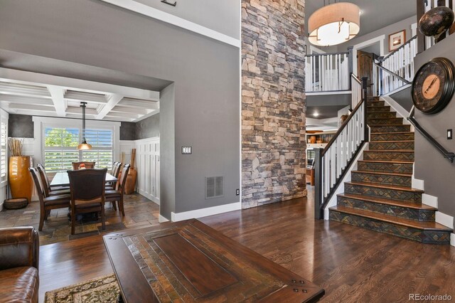 7243 S Kellerman Way, Aurora, CO 80016 - living area with baseboards, wood finished floors, coffered ceiling, stairs, and beam ceiling