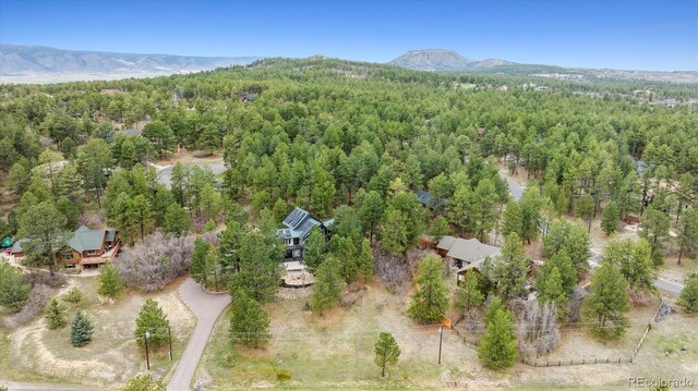 7317 Fremont Pl, Larkspur, CO 80118 - bird's eye view featuring a forest view and a mountain view
