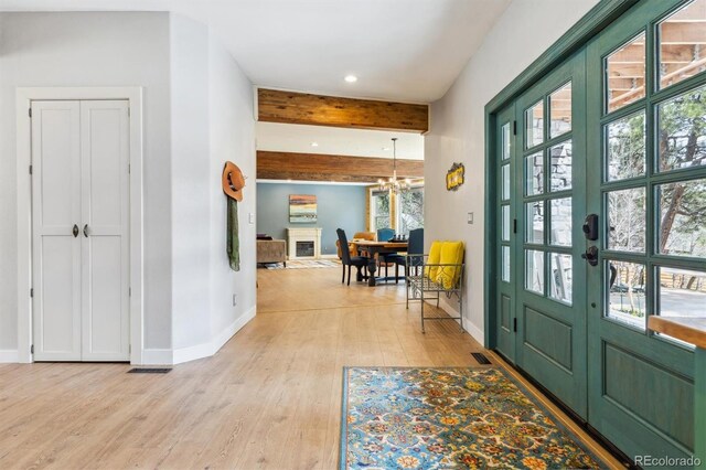 7317 Fremont Pl, Larkspur, CO 80118 - foyer with recessed lighting, beam ceiling, baseboards, a chandelier, and light wood-style flooring