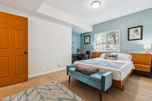 7317 Fremont Pl, Larkspur, CO 80118 - bedroom featuring wood finished floors and baseboards