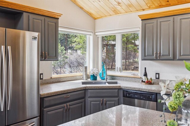 7317 Fremont Pl, Larkspur, CO 80118 - kitchen featuring vaulted ceiling, a sink, wooden ceiling, appliances with stainless steel finishes, and light stone countertops